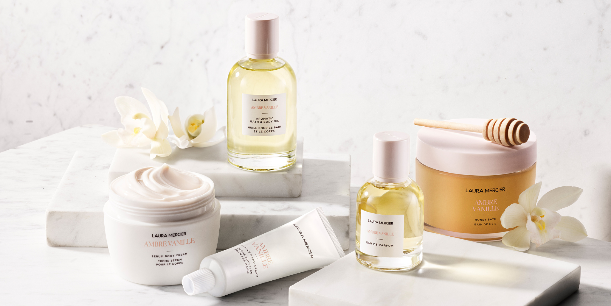 Line up of the Laura Mercier Ambre Vanille collection on a marble table