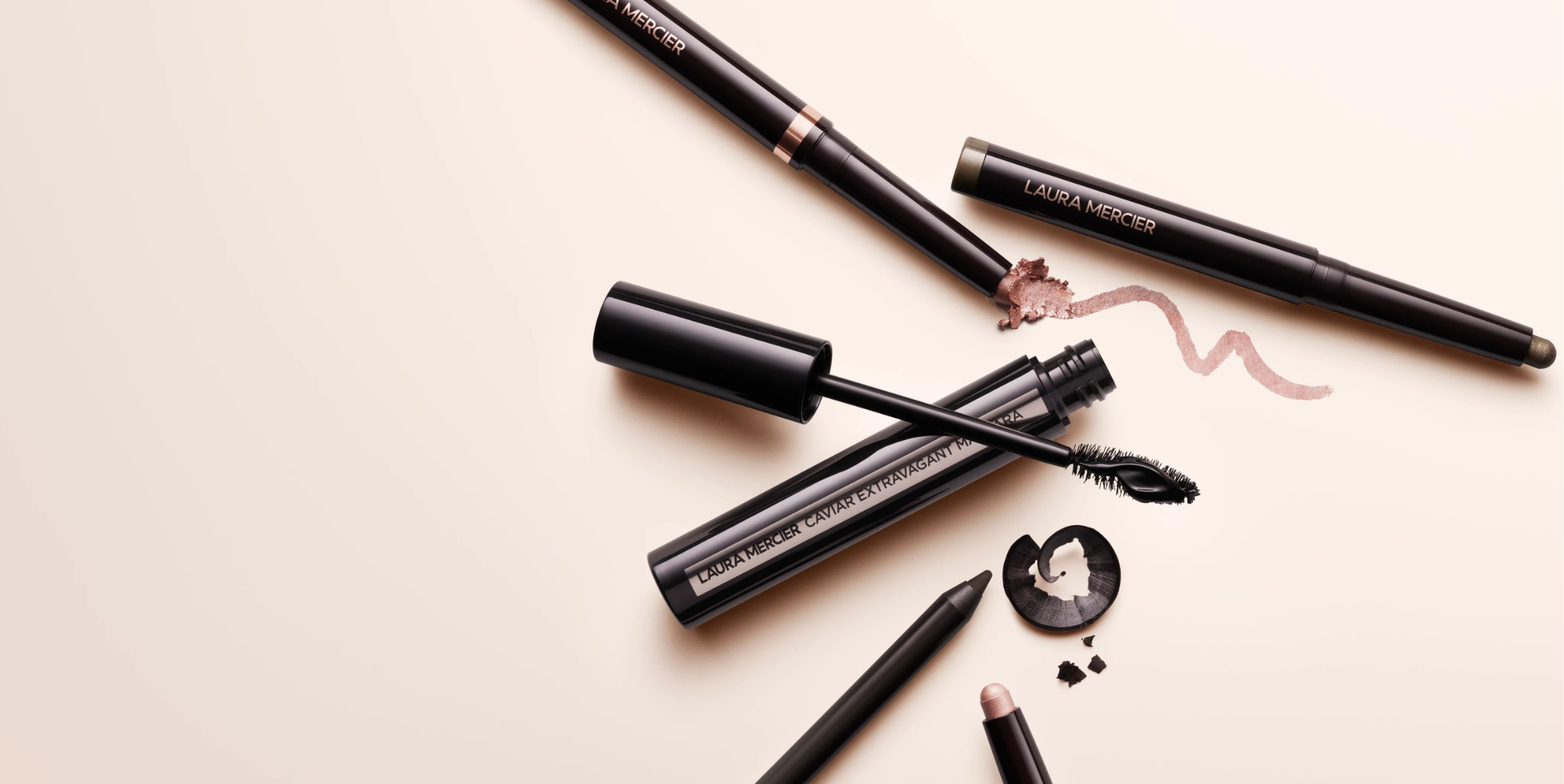 Laura Mercier Caviar Eye Collection laid down on a beige background