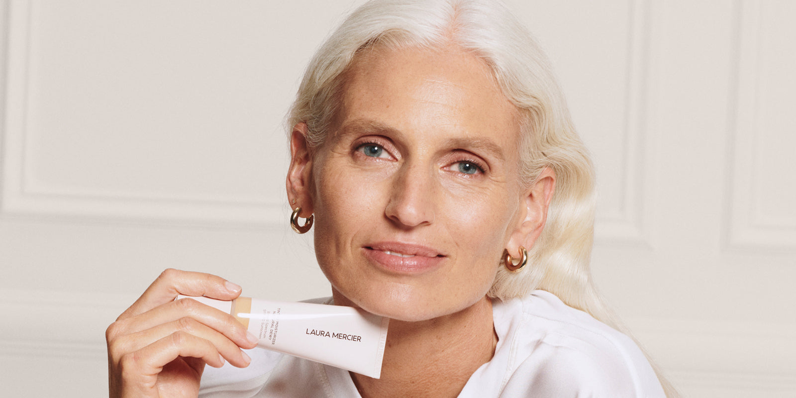 Model Holding Tinted Moisturizer Natural Dewy SPF 30