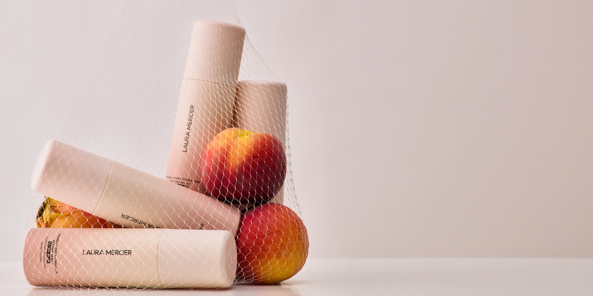 Setting spray and peaches in net bag