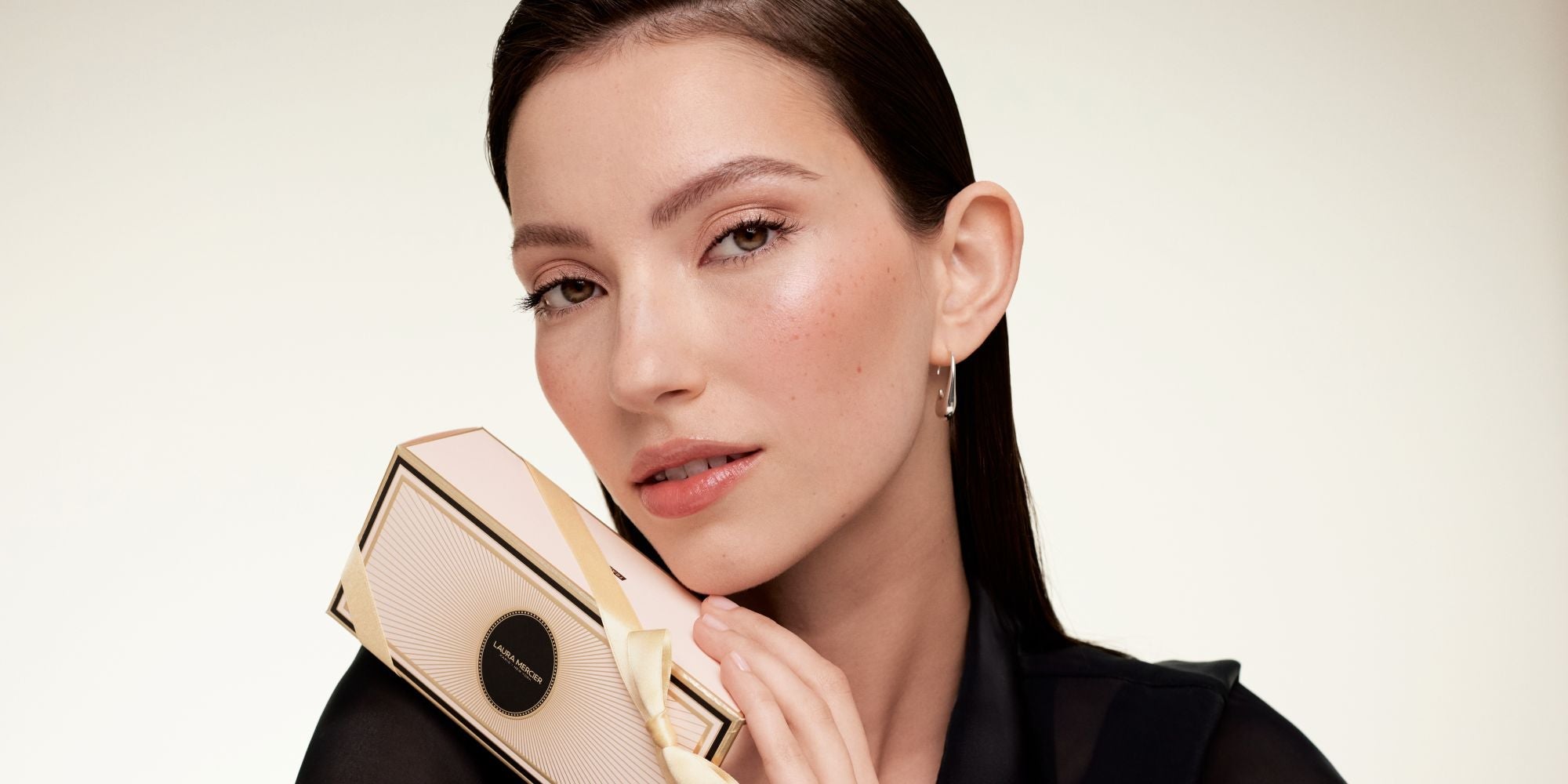 Model holding holiday makeup set box